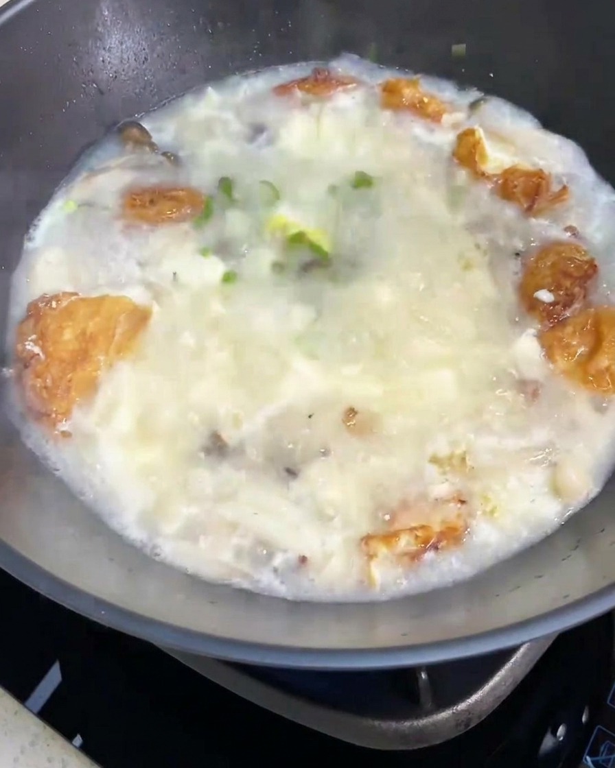 Gotowa zupa z grzybami i tofu udekorowana garścią świeżego szczypiorku.