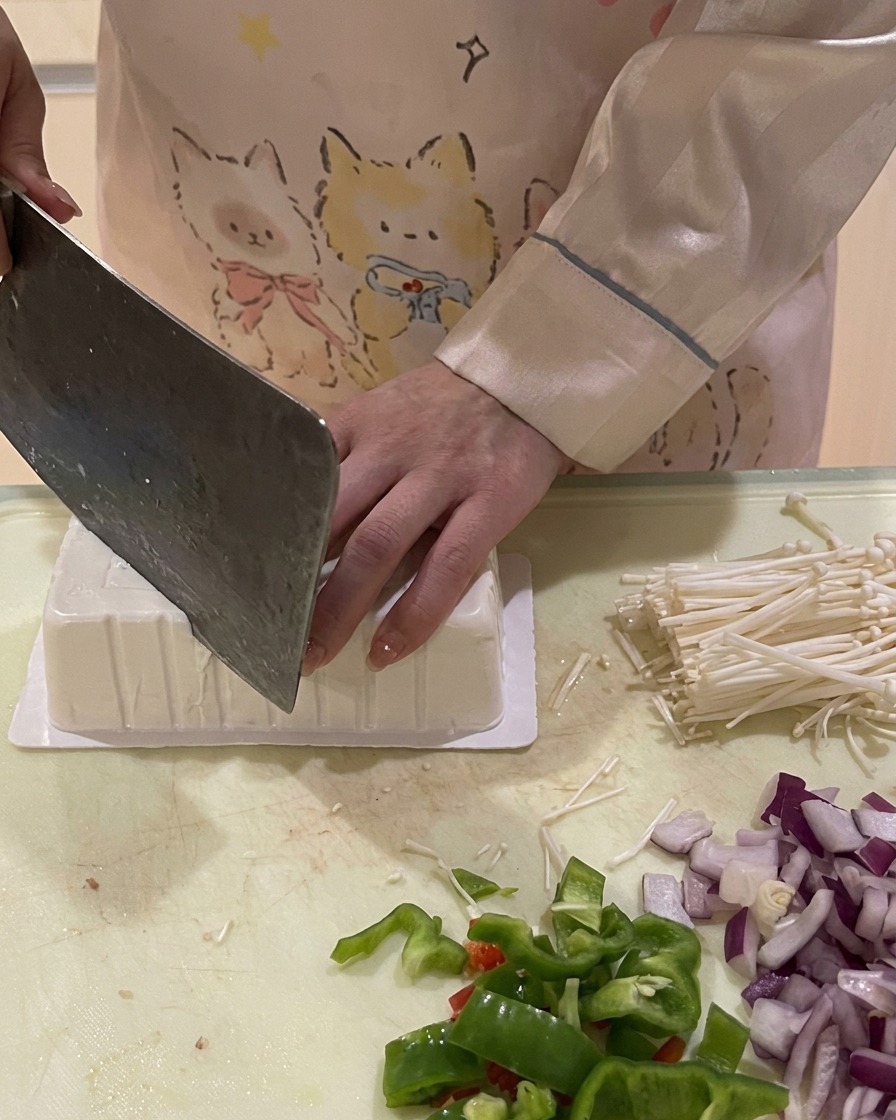 Nóż nacinający rogi odwróconego opakowania tofu, aby ułatwić jego wyjęcie.