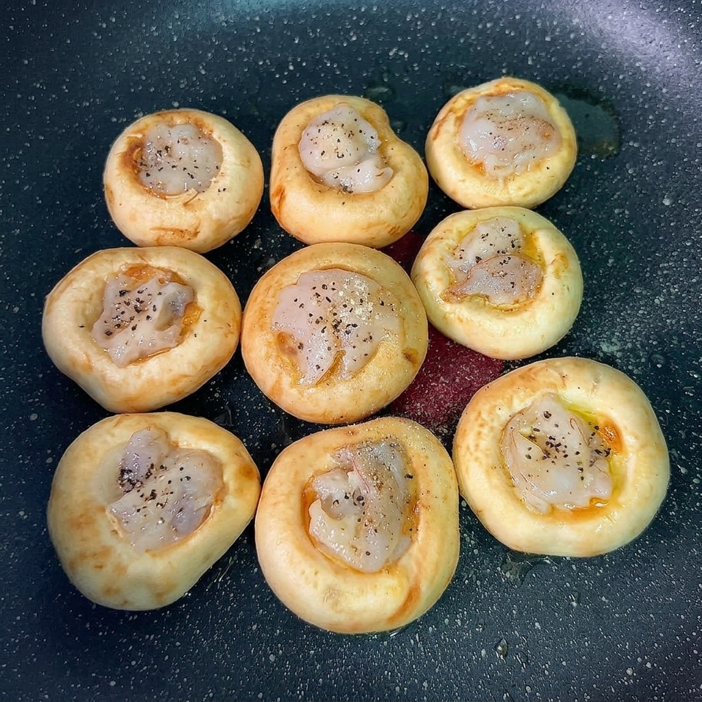 Podsmażone krewetki w pieczarkach gotowe do podania.