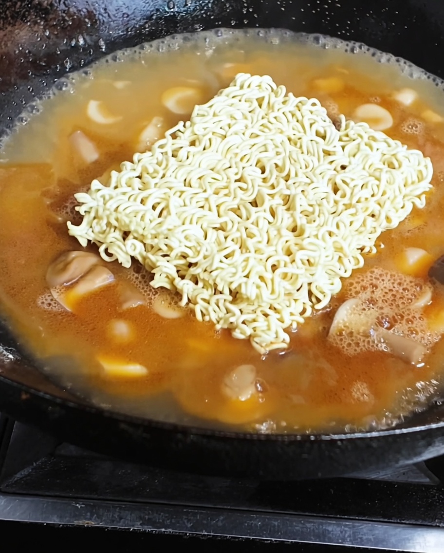 Makaron instant i sadzone jajko gotujące się w aromatycznym bulionie.