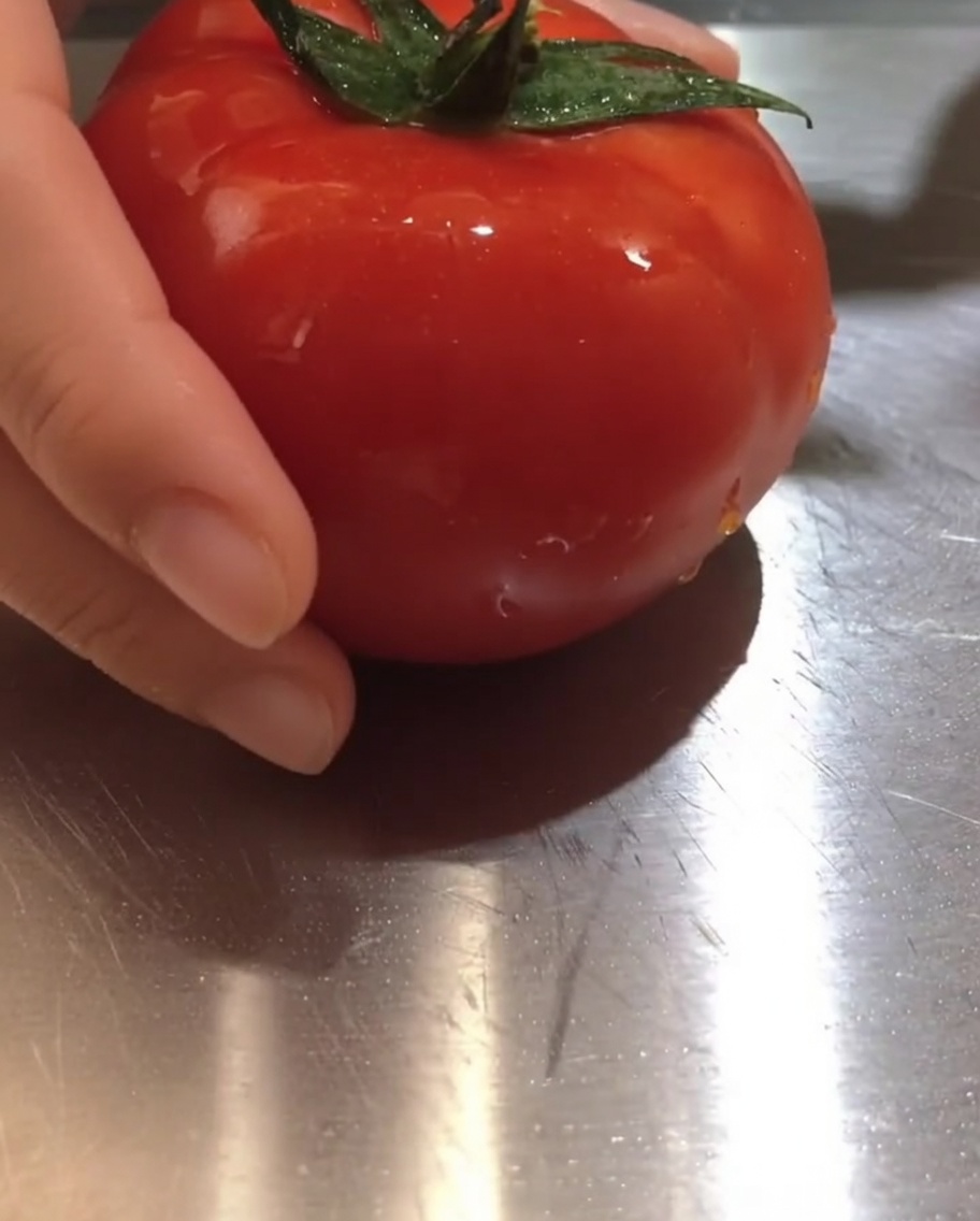 Kawałki świeżych pomidorów na desce do krojenia.